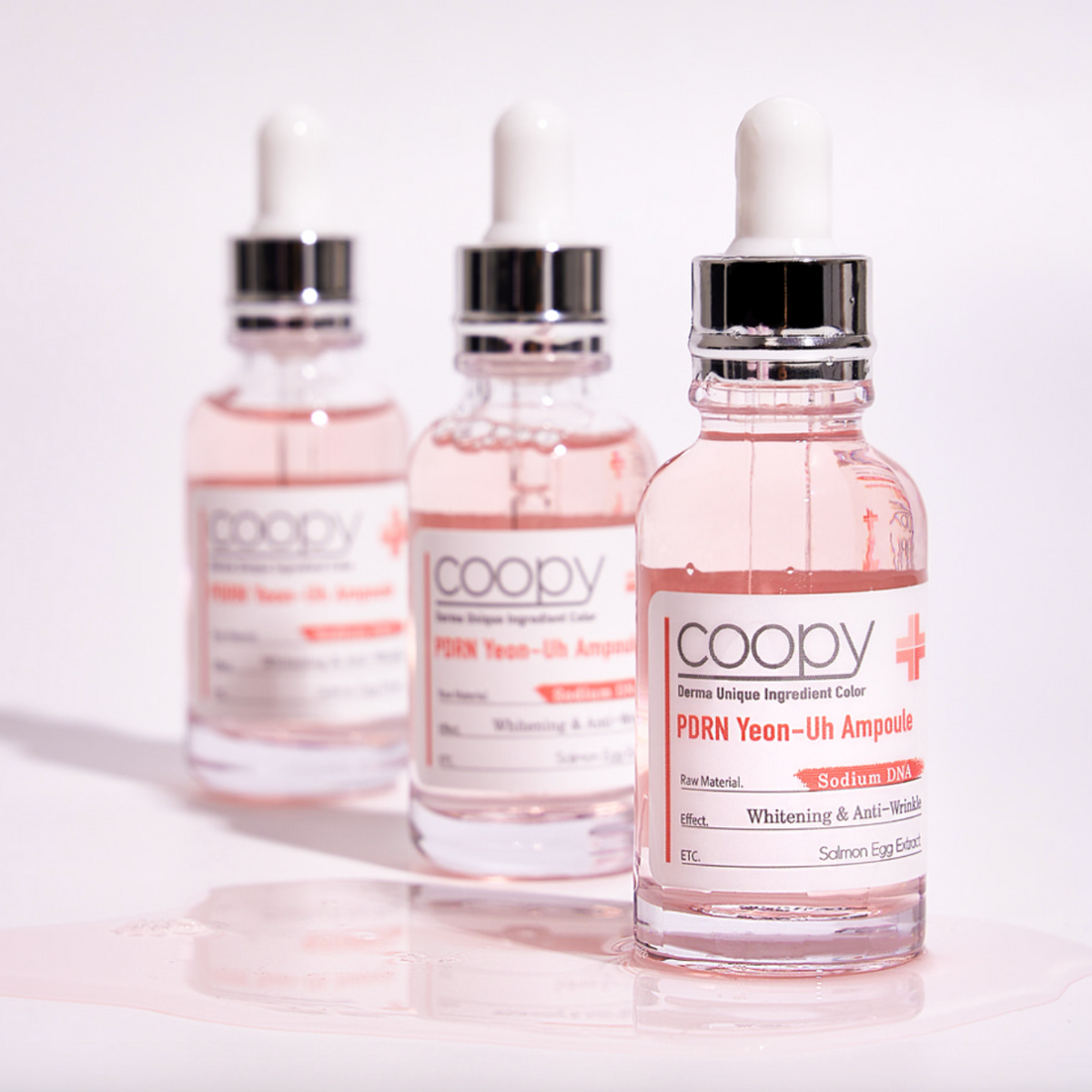 30ml COOPY PDRN Salmon Ampoule in a clear glass bottle with a pink label.