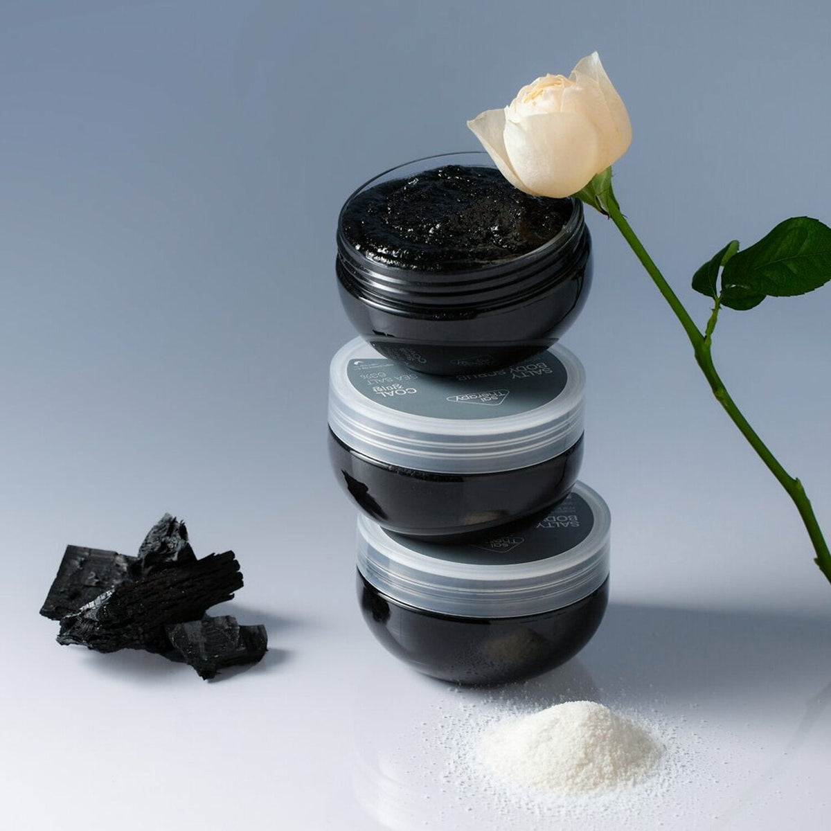 300g SalTherapy Salty Body Scrub in a clear jar with a pink label and sea salt.